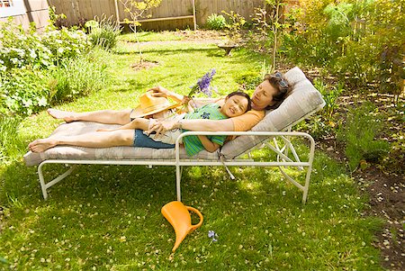 simsearch:673-02143625,k - Mother and son sleeping on lounge chair in backyard garden Stock Photo - Premium Royalty-Free, Code: 673-02216323