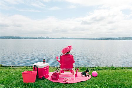 dog sitting down back view - Woman in pink and Boston Terrier dog picnicking by bay Stock Photo - Premium Royalty-Free, Code: 673-02216530