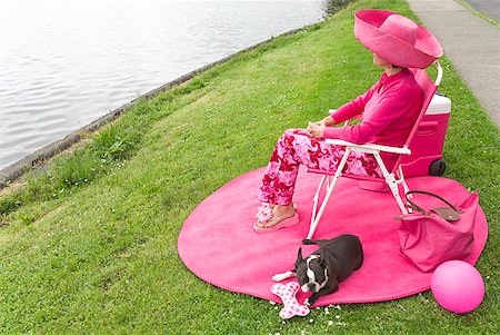 simsearch:673-02386607,k - Woman in pink and Boston Terrier dog picnicking by bay Stock Photo - Premium Royalty-Free, Code: 673-02216533