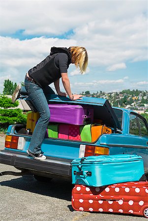 simsearch:600-07232294,k - Woman loading car trunk with colorful suitcases Stock Photo - Premium Royalty-Free, Code: 673-02216578