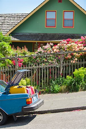 funny luggage - Car trunk loaded with colorful suitcases in front of house Stock Photo - Premium Royalty-Free, Code: 673-02216571