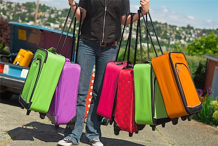 Woman carrying many colorful suitcases Stock Photo - Premium Royalty-Free, Code: 673-02216580