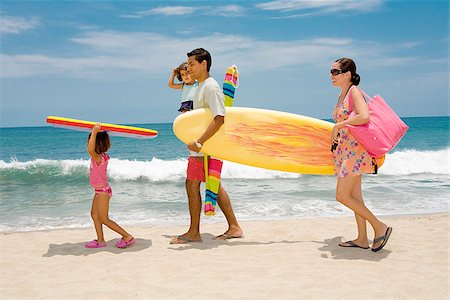 Couple with their children on the beach Stock Photo - Premium Royalty-Free, Code: 673-02386500