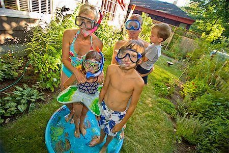 Family wearing snorkels and standing in a wading pool Stock Photo - Premium Royalty-Free, Code: 673-02386677