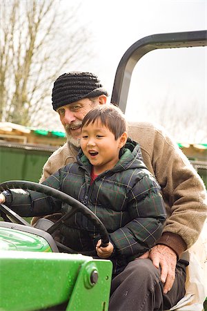 simsearch:673-02801432,k - Boy driving a tractor with assistance of male adult Stock Photo - Premium Royalty-Free, Code: 673-02801445