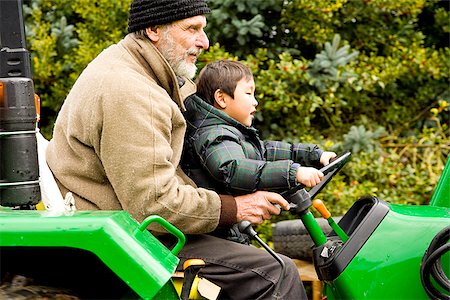 simsearch:673-02801432,k - Boy driving a tractor with assistance of male adult Stock Photo - Premium Royalty-Free, Code: 673-02801447