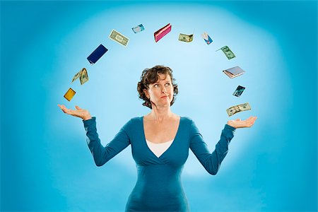 Woman juggling financial items Stock Photo - Premium Royalty-Free, Code: 673-03005420