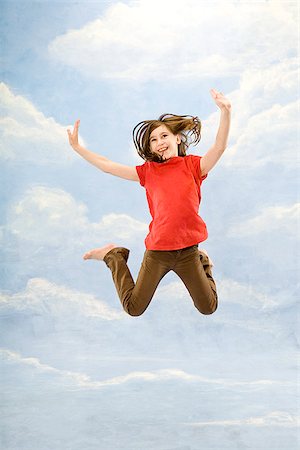 Child jumping in air Stock Photo - Premium Royalty-Free, Code: 673-03005443