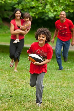 family playing football - Family running in park Stock Photo - Premium Royalty-Free, Code: 673-03005602