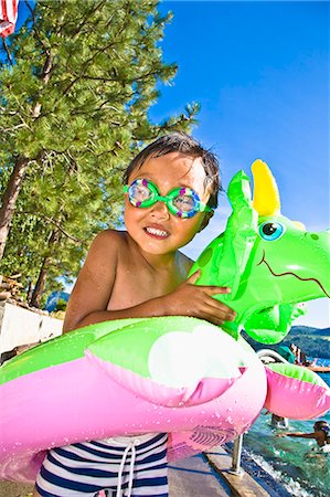 boy with dragon floatie and goggles Stock Photo - Premium Royalty-Free, Code: 673-03405741