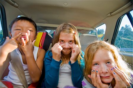 preteen girls faces photo - children making faces in car Stock Photo - Premium Royalty-Free, Code: 673-03826308