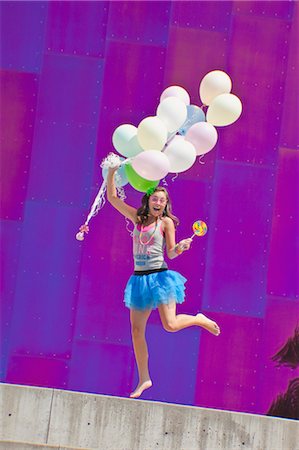 people jumping in party - teen girl holding bunch of balloons Stock Photo - Premium Royalty-Free, Code: 673-03826334