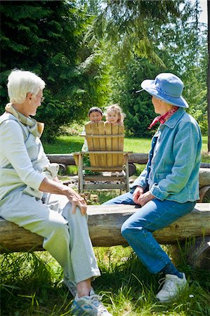 person sitting on a lawn chair - senior women looking at two children Stock Photo - Premium Royalty-Free, Code: 673-03826366