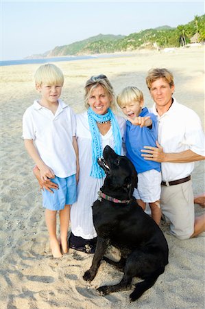 family on beach with dog Stock Photo - Premium Royalty-Free, Code: 673-03826422