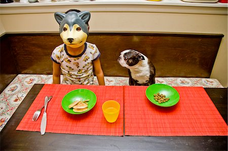 drinking water glass - boy wearing dog mask at table Stock Photo - Premium Royalty-Free, Code: 673-03826558