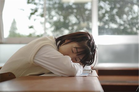 High school girl sleeping at her desk in classroom Stock Photo - Premium Royalty-Free, Code: 685-02937156