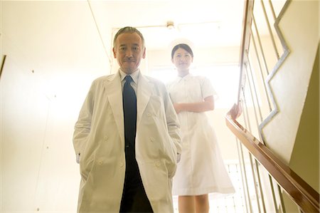 doctor nurse walking - Doctor and female nurse descending staircases Stock Photo - Premium Royalty-Free, Code: 685-02938358