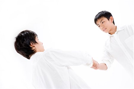 Teenage boys shaking hands Stock Photo - Premium Royalty-Free, Code: 685-02941036