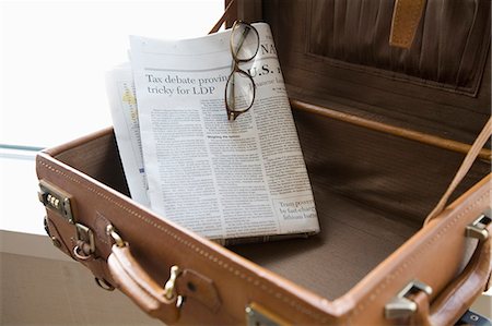 empty suitcase - Newspaper in suitcase Stock Photo - Premium Royalty-Free, Code: 685-02941651