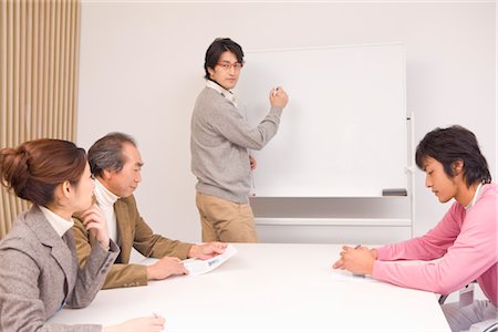 Four people discussing in meeting room Stock Photo - Premium Royalty-Free, Code: 685-03082269