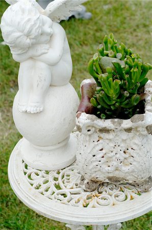 Putto and plant in garden Stock Photo - Premium Royalty-Free, Code: 689-05610162