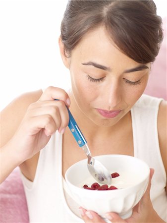 simsearch:689-03733468,k - Woman eating yogurt with raspberries Stock Photo - Premium Royalty-Free, Code: 689-05610291