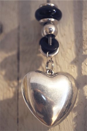 simsearch:695-03386286,k - Necklace with heart-shaped pendant Stock Photo - Premium Royalty-Free, Code: 689-05610557