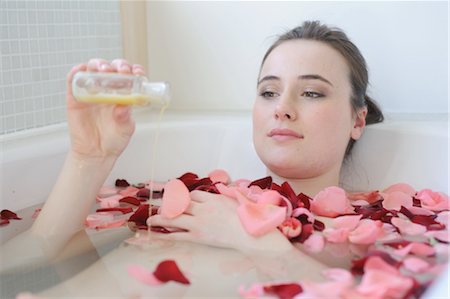 pampered - Young woman enjoying bath with rose petals Stock Photo - Premium Royalty-Free, Code: 689-05611992