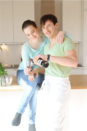 food in containers - Young couple drinking red wine in kitchen Stock Photo - Premium Royalty-Free, Code: 689-05612009