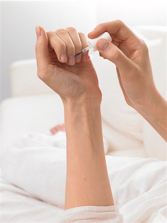 Woman is varnishing her nails Stock Photo - Premium Royalty-Free, Code: 689-03124806