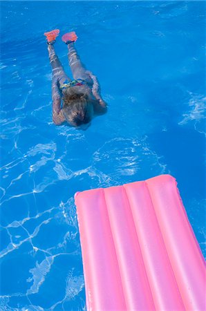 flippers - Woman diving in the water and a air mattress Stock Photo - Premium Royalty-Free, Code: 689-03125652