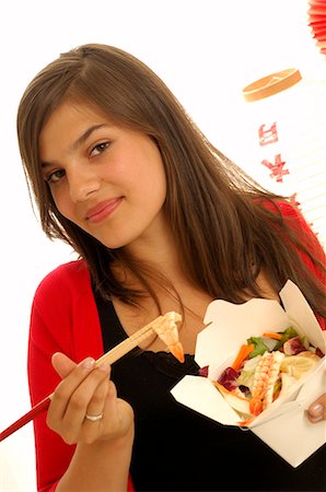 Woman eating asian dish with chopsticks Stock Photo - Premium Royalty-Free, Code: 689-03128543