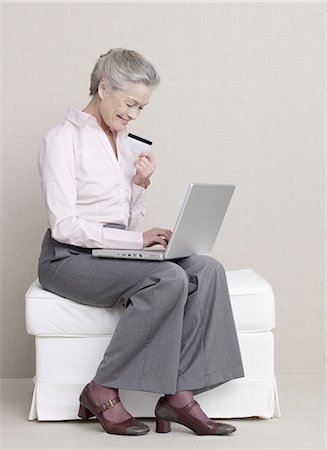 Senior adult with laptop and credit card Stock Photo - Premium Royalty-Free, Code: 689-03129286