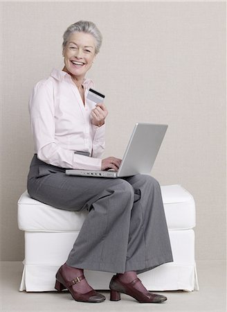 Senior adult with laptop and credit card Stock Photo - Premium Royalty-Free, Code: 689-03129287