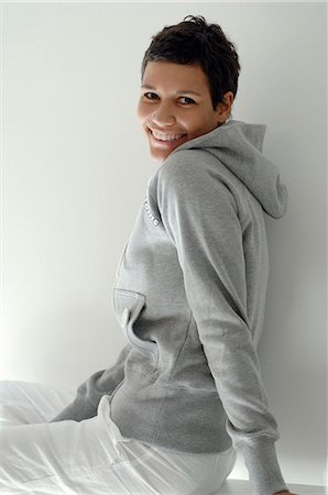 sweatshirt - Young woman with grey sweater Stock Photo - Premium Royalty-Free, Code: 689-03130757