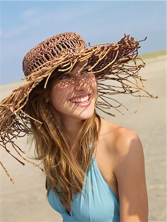 Young woman in a summerdress and with hat Stock Photo - Premium Royalty-Free, Code: 689-03131021