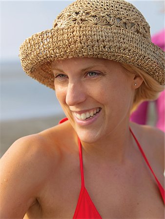 Young woman with hat on the beach Stock Photo - Premium Royalty-Free, Code: 689-03131070