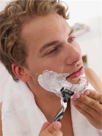 young man shaving Stock Photo - Premium Royalty-Free, Code: 689-03131338