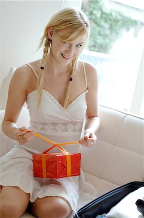 Young woman wrapping present Stock Photo - Premium Royalty-Free, Code: 689-03733001