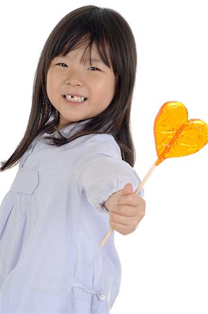 Girl holding lollipop Stock Photo - Premium Royalty-Free, Code: 689-03733331