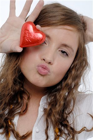 simsearch:400-05368603,k - Woman pouting holding chocolate heart Stock Photo - Premium Royalty-Free, Code: 689-03733421