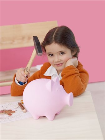 economy tool - Girl with hammer and piggy bank Stock Photo - Premium Royalty-Free, Code: 689-03733700