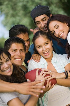 friends playing american football - Group of young people playing football. Stock Photo - Premium Royalty-Free, Code: 694-03318194