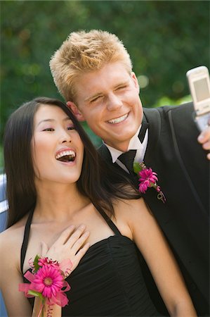 prom dresses - Well-dressed teenagers taking photo with camera phone outside Stock Photo - Premium Royalty-Free, Code: 694-03318735
