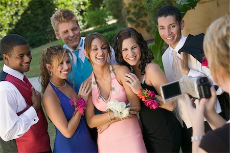 Well-dressed teenagers posing for video camera outside school dance Stock Photo - Premium Royalty-Free, Code: 694-03318759