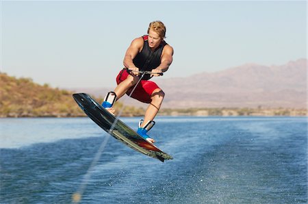 fast action - Young man wakeboarding on lake Stock Photo - Premium Royalty-Free, Code: 694-03327026