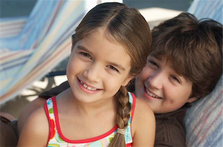 Girl and boy on deck chair, portrait Stock Photo - Premium Royalty-Free, Code: 694-03327208