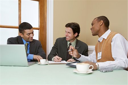 Three business men talking Stock Photo - Premium Royalty-Free, Code: 694-03327677
