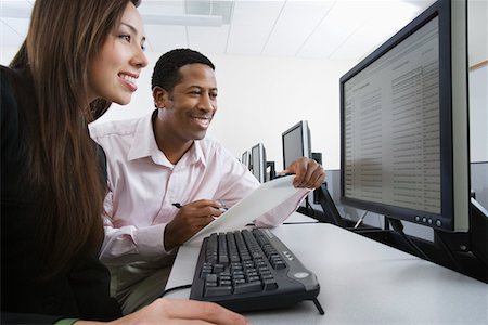 Man and woman using computer together Stock Photo - Premium Royalty-Free, Code: 694-03327912
