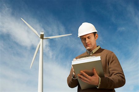 Engineer working near wind turbine at wind farm Stock Photo - Premium Royalty-Free, Code: 694-03328173